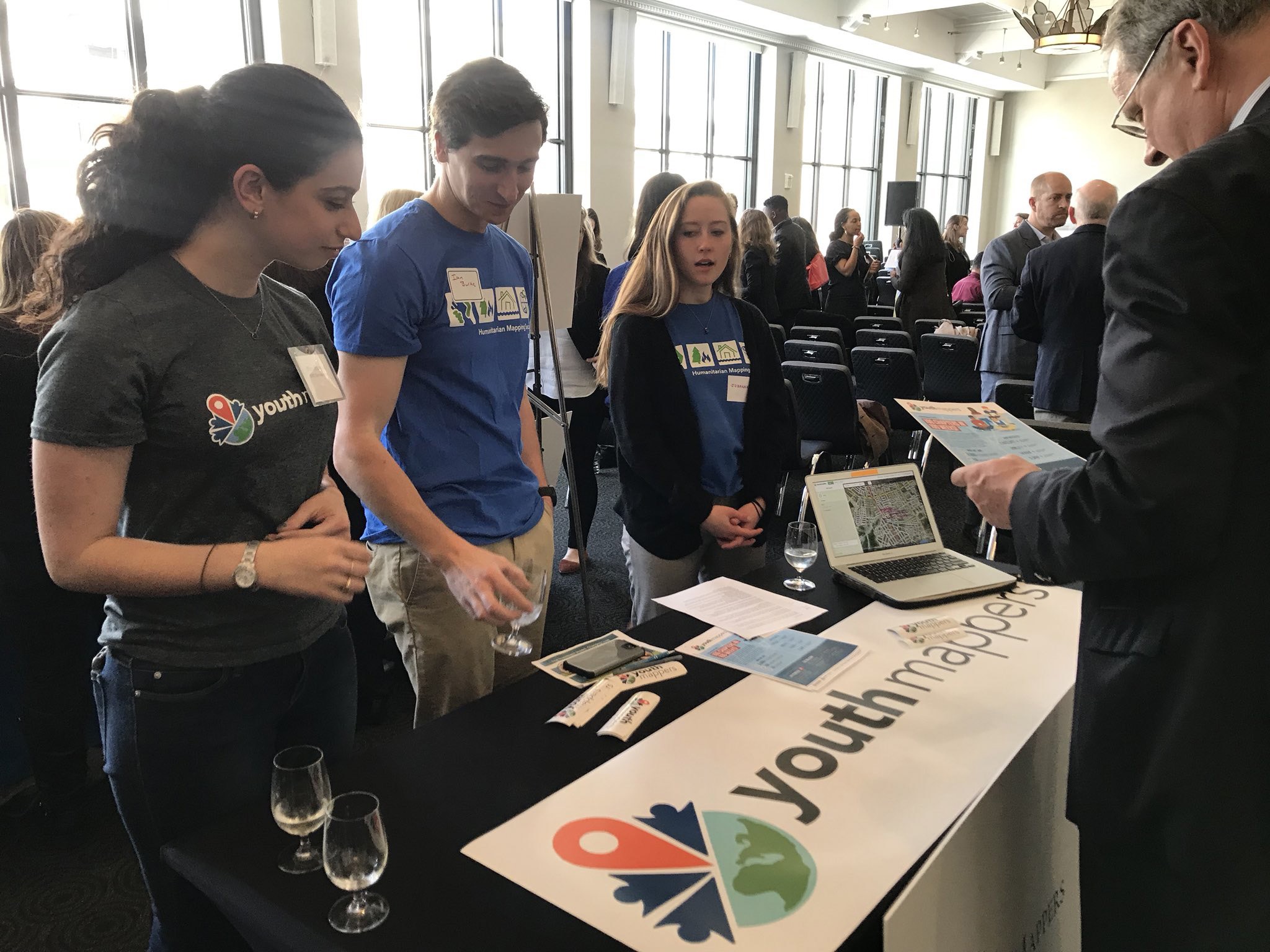 Group of students showcasing their community mapping project with YouthMappers